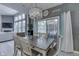 Inviting dining area featuring a modern chandelier, large windows, and access to outdoor patio space at 2502 Colinbrook Pkwy, Greenwood, IN 46143
