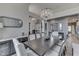 Elegant dining room with modern chandelier, hardwood floors, and comfortable seating around a large wooden table at 2502 Colinbrook Pkwy, Greenwood, IN 46143