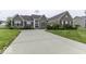 Charming brick home featuring a well-manicured lawn and an expansive driveway at 2502 Colinbrook Pkwy, Greenwood, IN 46143