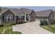 Attractive brick home featuring an attached garage, lush landscaping, and an inviting curb appeal at 2502 Colinbrook Pkwy, Greenwood, IN 46143