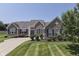 Attractive brick home featuring manicured lawn, tidy shrubbery, and symmetrically placed windows at 2502 Colinbrook Pkwy, Greenwood, IN 46143