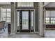 Welcoming foyer boasts a glass-paneled front door, neutral walls, and wood-look flooring at 2502 Colinbrook Pkwy, Greenwood, IN 46143