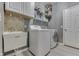 A functional laundry room equipped with a sink, washer, and dryer at 2502 Colinbrook Pkwy, Greenwood, IN 46143