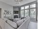 Bright living room features a corner fireplace, large windows, and a comfortable sofa with stylish pillows at 2502 Colinbrook Pkwy, Greenwood, IN 46143