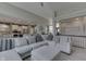 Bright, open living room with a large sectional, fireplace, and views into the modern kitchen at 2502 Colinbrook Pkwy, Greenwood, IN 46143