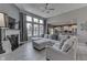 Open-concept living room with large windows, modern fireplace, and a glimpse into the connected kitchen at 2502 Colinbrook Pkwy, Greenwood, IN 46143