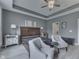 Bedroom with tray ceilings, ample natural light, and decorative ceiling fan at 2502 Colinbrook Pkwy, Greenwood, IN 46143