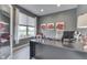 Modern office features a sleek desk, floral art, and a window overlooking a lush green landscape at 2502 Colinbrook Pkwy, Greenwood, IN 46143