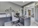 Bright home office with modern decor, sleek desk, and glass doors leading to other rooms at 2502 Colinbrook Pkwy, Greenwood, IN 46143
