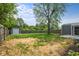 A large, flat backyard with a storage shed and wooden fence, perfect for outdoor activities at 2537 N Boehning St, Indianapolis, IN 46219