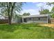 Exterior view of the home showcasing the green backyard and large sliding glass doors at 2537 N Boehning St, Indianapolis, IN 46219
