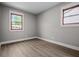 An empty bedroom with vinyl floors and two windows allowing natural light to come inside at 2537 N Boehning St, Indianapolis, IN 46219