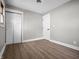 Bedroom with vinyl flooring, an overhead light, two doors and one window at 2537 N Boehning St, Indianapolis, IN 46219