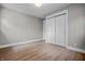 An empty bedroom features vinyl floors, an overhead light, and a closet with sliding doors at 2537 N Boehning St, Indianapolis, IN 46219