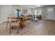 An open layout dining room and living room area featuring a modern design and wood floors and neutral colored walls at 2537 N Boehning St, Indianapolis, IN 46219