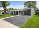 Charming ranch-style home with a well-manicured lawn, a driveway, and an attached one car garage at 2537 N Boehning St, Indianapolis, IN 46219