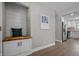 Hallway features built in bench seating and access to kitchen with stainless steel appliances at 2537 N Boehning St, Indianapolis, IN 46219