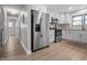 Modern kitchen with wood floors, stainless steel appliances, white cabinets, and recessed lights creating a sleek space at 2537 N Boehning St, Indianapolis, IN 46219