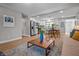 Modern kitchen open to dining and living areas, featuring stainless steel appliances, white cabinets, and wood flooring at 2537 N Boehning St, Indianapolis, IN 46219