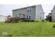 Well-maintained backyard with a large lawn, wooden deck, and a charming swing at 2786 Longleaf Dr, Greenwood, IN 46143