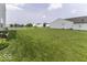 Large backyard with a view of a serene pond and surrounding homes at 2786 Longleaf Dr, Greenwood, IN 46143