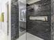 Modern bathroom with a beautiful stone tiled shower, glass enclosure, and built-in niche for toiletries at 2786 Longleaf Dr, Greenwood, IN 46143