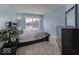 Light-filled bedroom with blue walls, dark furniture, patterned bedding, and a bright window view at 2786 Longleaf Dr, Greenwood, IN 46143