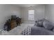 Bedroom with large window, gray walls, plush carpet, and comfortable sitting area at 2786 Longleaf Dr, Greenwood, IN 46143