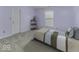 Comfortable bedroom with neutral walls, simple furniture, a large window and plush carpeting at 2786 Longleaf Dr, Greenwood, IN 46143