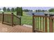 Wooden deck overlooks a well-manicured lawn and a tranquil pond at 2786 Longleaf Dr, Greenwood, IN 46143