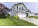 Corner view of a home featuring a two-car garage, well maintained lawn, and landscaped garden at 2786 Longleaf Dr, Greenwood, IN 46143