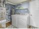 Laundry area with washer, dryer, shelving, and hardwood floors at 2786 Longleaf Dr, Greenwood, IN 46143
