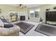 Cozy living room with a fireplace, large window, and neutral carpet at 2786 Longleaf Dr, Greenwood, IN 46143