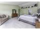 Spacious main bedroom featuring a large bed, dresser, and comfortable couch at 2786 Longleaf Dr, Greenwood, IN 46143