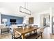 Open dining space with wood table, chairs, stylish light fixture, and seamless flow to living area at 2946 Woods Edge Dr, Greenwood, IN 46143