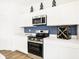 Modern kitchen with white cabinetry, stainless steel appliances, and sleek quartz countertops at 2946 Woods Edge Dr, Greenwood, IN 46143