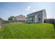 Large backyard with healthy green lawn, wooden fence and views of the rear exterior at 3010 Underwood Ct, Whiteland, IN 46184
