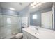 Clean bathroom featuring a glass-enclosed shower, white vanity, and a large mirror, creating a refreshing space at 3010 Underwood Ct, Whiteland, IN 46184