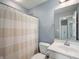 Bright bathroom featuring a shower with a patterned curtain, white vanity, and an open floorplan at 3010 Underwood Ct, Whiteland, IN 46184