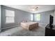 Large carpeted bedroom features natural light, a ceiling fan, and a TV on a stand at 3010 Underwood Ct, Whiteland, IN 46184