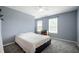 Bright bedroom with neutral tones, plush carpet, and ample natural light from the window at 3010 Underwood Ct, Whiteland, IN 46184