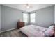 Bedroom featuring a dresser and a bed with a colorful comforter under natural light at 3010 Underwood Ct, Whiteland, IN 46184