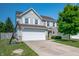 Two-story home featuring a two car garage, neutral siding and partial stone accents plus well kept lawn at 3010 Underwood Ct, Whiteland, IN 46184