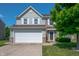 Two-story home featuring a two car garage, neutral siding and partial stone accents plus manicured lawn at 3010 Underwood Ct, Whiteland, IN 46184