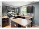 Compact kitchen with stainless appliances, modern cabinets, an island, and tile backsplash at 3010 Underwood Ct, Whiteland, IN 46184