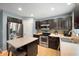Well-lit kitchen featuring stainless steel appliances, dark cabinetry, an island, and a decorative backsplash at 3010 Underwood Ct, Whiteland, IN 46184