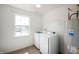 Neat laundry room with a washer, dryer, and water heater, illuminated by a window offering natural light at 3010 Underwood Ct, Whiteland, IN 46184