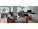 Open-concept living and dining area featuring neutral walls, modern furniture, and a view to the workout space at 3010 Underwood Ct, Whiteland, IN 46184