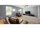 Comfortable living room with plush carpeting and dark sofas featuring a view of the landscaped outdoors at 3010 Underwood Ct, Whiteland, IN 46184