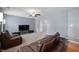 Comfortable living room offering neutral walls, plush carpet and dark sofas with media center at 3010 Underwood Ct, Whiteland, IN 46184